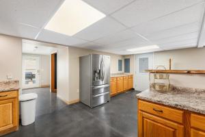 a large kitchen with a stainless steel refrigerator at Mt Rushmore Duplex in Rapid City