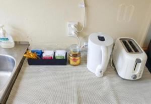 a kitchen counter with a toaster next to a sink at Stylish Tawa Retreat in Wellington