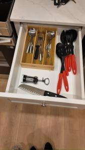 a drawer filled with cooking utensils on a counter at Central Luxe in Surrey
