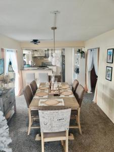 a dining room with a wooden table and chairs at Cozy Stays in Oranjestad
