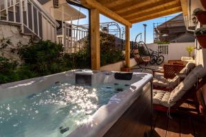 a jacuzzi tub on the deck of a house at Queen Hvar Luxury Apartment Jacuzzi & Bikes in Hvar