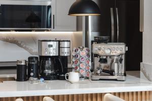a kitchen counter with a coffee maker on a counter top at New Sunset Villa Ocean Side Lanai Pool Kings in Waikoloa +189 photos