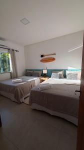 a bedroom with two beds and a window at Espaço Move in Porto Seguro