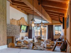 a dining room with a table with glasses on it at Tauernlodge Wagrain Edelweiss 42E in Wagrain