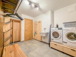 a laundry room with a washing machine and a sink at Tauernlodge Wagrain Edelweiss 42E in Wagrain