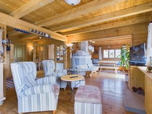 a living room with white furniture and a wooden ceiling at Bergsehnsucht in Hippach