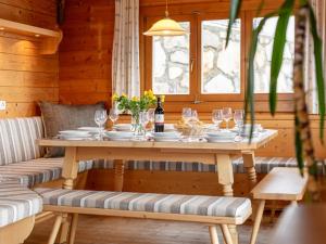 a wooden table with plates and wine glasses on it at Bergsehnsucht in Hippach