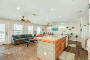 a kitchen and living room with a large counter top at Paradise Point - Barefoot Beachfront Living in Surfside Beach +30 photos