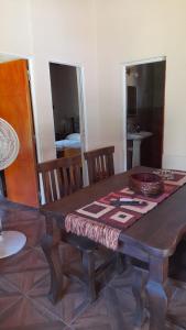 a wooden table with a table cloth on top of it at Cabaña LA SOÑADA in Villa Anizacate