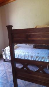 a wooden bunk bed in a room at Cabaña LA SOÑADA in Villa Anizacate