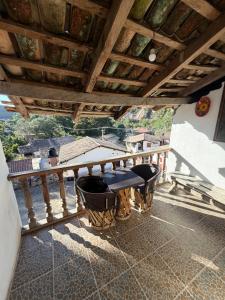 a balcony with a table and chairs on a porch at Hotel del Pozo in San Sebastián del Oeste