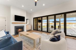 a living room with two chairs and a fireplace at Bay Dreaming in Montross