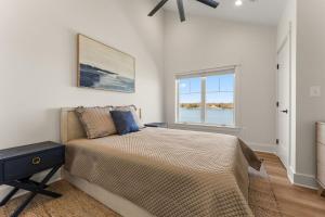 a bedroom with a large bed and a window at Bay Dreaming in Montross