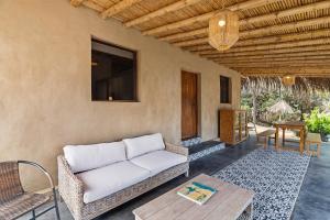a living room with a couch and a table at ALDEA DEL MAR by Villa del Sol in Máncora