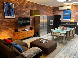 a living room with a couch and a table and a kitchen at beachside loft warehouse artists retreat in Edithvale