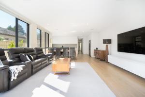 a living room with a couch and a table at Mid-Century Home Near Hospital and Woden - Hosted by Canstay in Phillip +23 photos