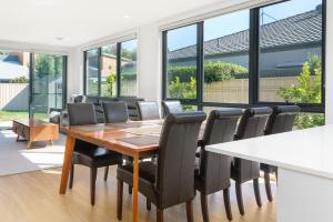 a dining room with a table and chairs at Mid-Century Home Near Hospital and Woden - Hosted by Canstay in Phillip