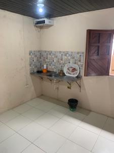 a small kitchen with a sink and a window at Espaço Victoria in Caruaru +5 photos