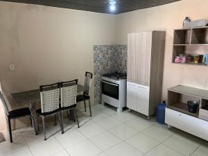 a kitchen with a table and a stove and a refrigerator at Espaço Victoria in Caruaru