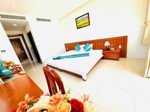 a bedroom with a bed and a desk and a table at Hòn Chồng Hotel in Nha Trang