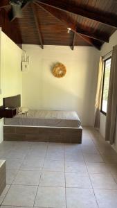 a bedroom with a bed in the corner of a room at Green Point Nosara in Nosara
