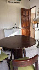 a kitchen with a wooden table and some chairs at Green Point Nosara in Nosara