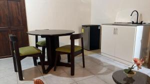 a kitchen with a table and chairs and a sink at Green Point Nosara in Nosara