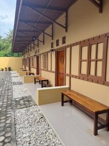 a row of benches on the side of a building at Loko Stay Syariah in Krui