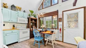 a kitchen with a table and chairs and a dining room at Bear Cabin Hideout in Hamlin