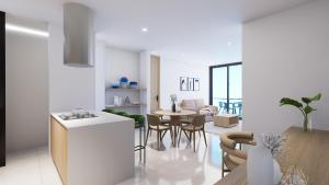 a kitchen and living room with a table and chairs at Nuruma Suites by Avia Suites in Santa Marta