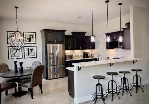 a kitchen with a table and some chairs and a counter at Parker Strip Vacation Villa in Parker