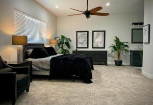 a bedroom with a bed and a ceiling fan at Parker Strip Vacation Villa in Parker
