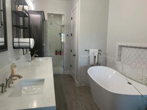 a white bathroom with a tub and a shower at Parker Strip Vacation Villa in Parker +12 photos