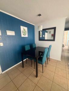 a dining room with a table and blue walls at Refugio inca in Cusco