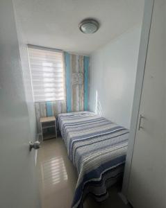 a bedroom with a bed in a room with a window at Refugio inca in Cusco +1 photo