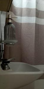a bathroom sink with a soap dispenser on top of it at Casa Nur in Potrerillos