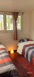 a bedroom with two beds and a window at Casa Nur in Potrerillos