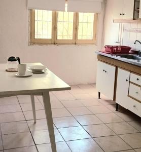 a kitchen with a table and a sink at Casa Nur in Potrerillos