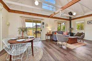 a living room with a table and chairs at The Meadow Suite in Pokolbin