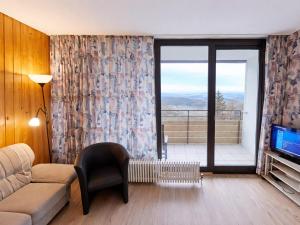 a living room with a couch and a tv at Studio Sebastian mit Pool und Sauna in Freyung