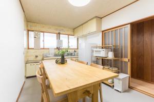 a kitchen with a wooden table in a room at オオジンマチ ハイツ302 in Takayama +41 photos