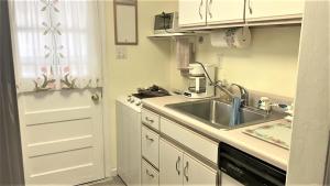 a kitchen with a sink and a counter top at Rulons Cape May Diamond, 2Nd in Cape May +10 photos