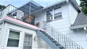 a house with a spiral staircase and a balcony at Rulons Cape May Diamond, 2Nd in Cape May