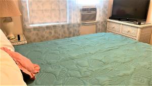 a bedroom with a large bed with a television on it at Rulons Cape May Diamond, 2Nd in Cape May