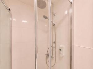 a shower with a glass door in a bathroom at Studio Michaela mit Pool und Sauna in Freyung +24 photos