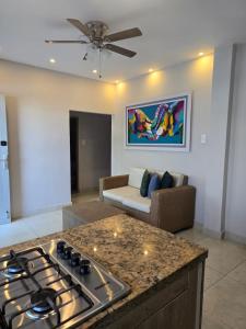 a living room with a stove and a couch at Amoblados la 19 in Ríohacha