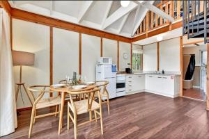 a kitchen with a table and chairs in a room at The Orchard Suite in Pokolbin