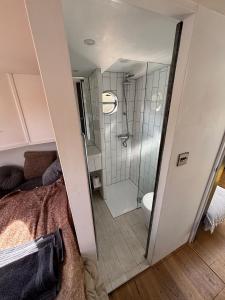 a bathroom with a shower and a bed in a room at Unique 2 Bed Waterside Retreat Pet Friendly in Upton upon Severn +23 photos