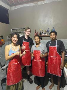 a group of four people wearing red aprons at Dewi Teduh Villa in Sidemen