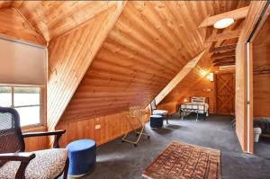 an attic room with a wooden ceiling at The Ridge Stables in Pokolbin